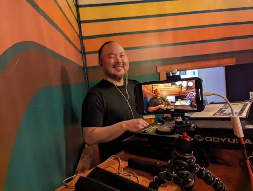 sangdo playing a live set with a smartphone camera mounted on a flexible tripod