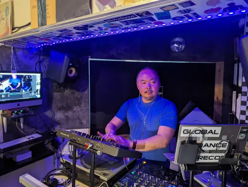 sangdo at a professionally lit studio setup with Pioneer DJ equipment and Global Dance Records branding
