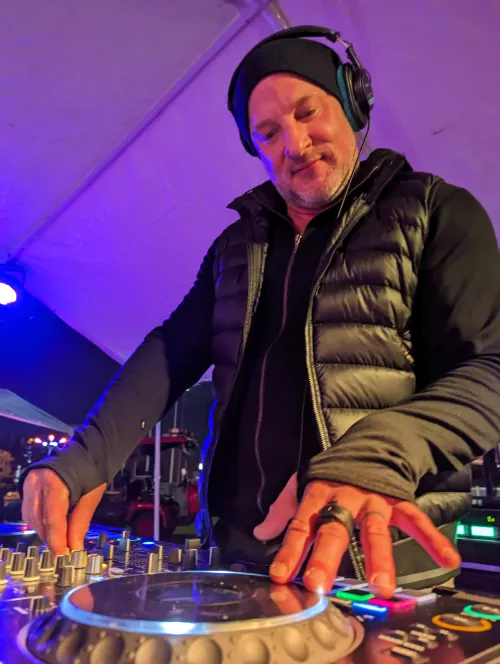 Two DJs posing with Seattle House Mafia merchandise and DJ equipment