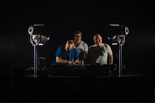 The Seattle House Mafia trio performing together on a darkened stage at Q Nightclub